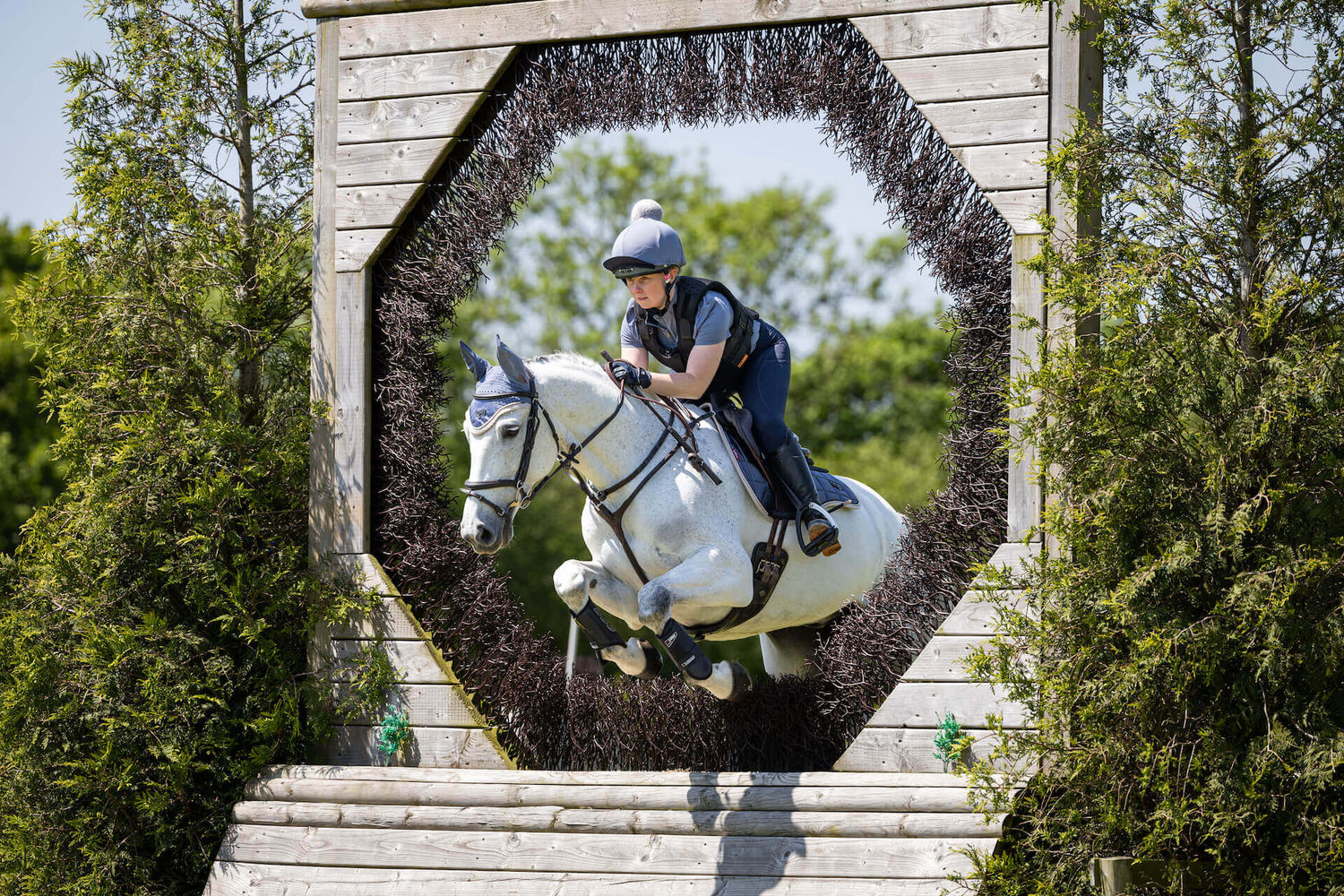 Hourse jumping and a boy riding