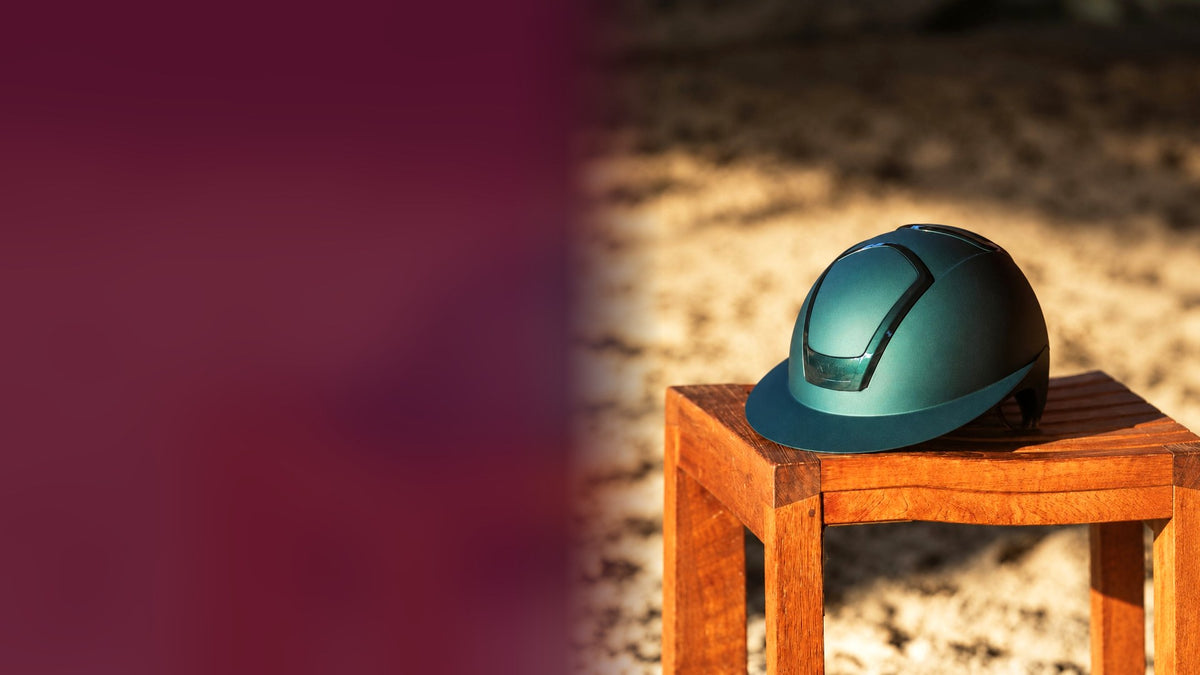 Teal riding helmet on a wooden stool. In-store shopping weekend at Ayr Equestrian, up to 75% off, 3–4 October.